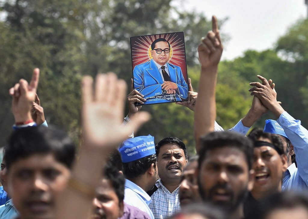 Members of Dalit community display a portrait of Bhim Rao Ambedkar during 'Bharat Bandh' in New Delhi | PTI