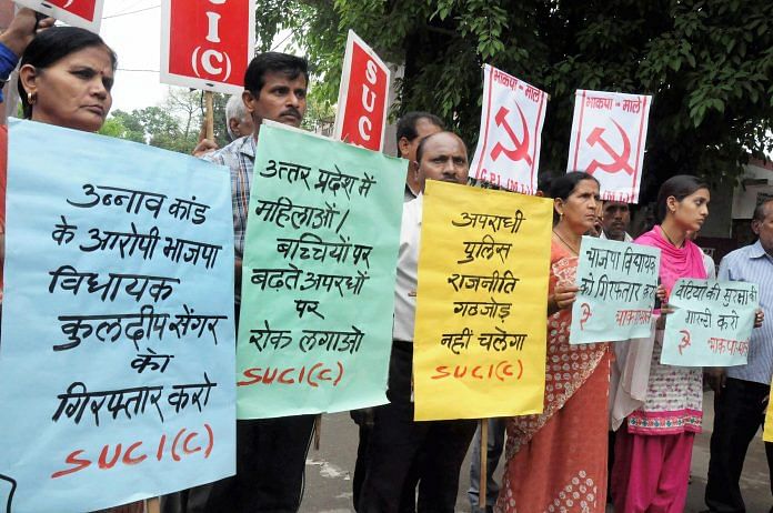Activists display placards during a protest over Unnao rape case, in Moradabad on Wednesday | PTI