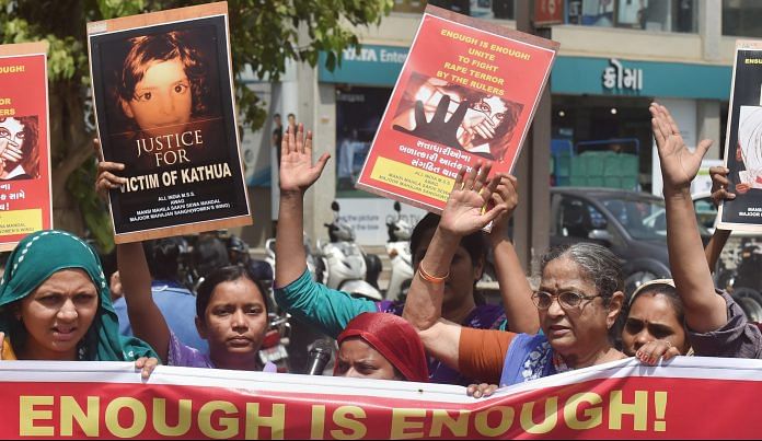 People display placards as they protest over government's alleged 'inaction' in Kathua and Unnao rape cases | PTI