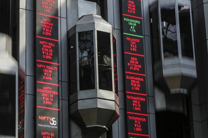 Elevators travel next to electronic boards at the National Stock Exchange of India | Bloomberg