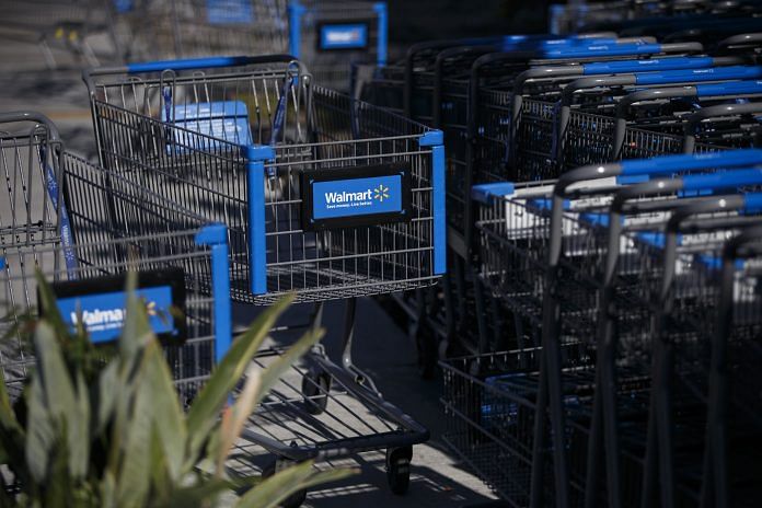 The Walmart Stores Inc. logo is displayed on shopping carts outside the company's location in U.S.