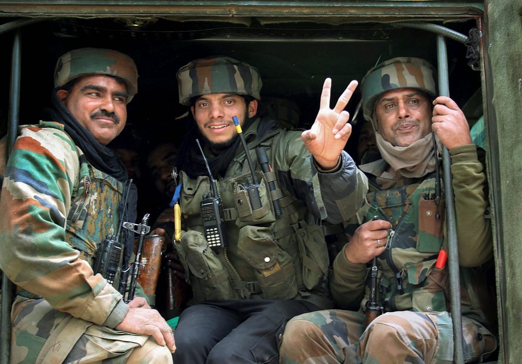 Shopian: Army personnel show victory sign after the killing of top militant commanders including Sadaam Padar