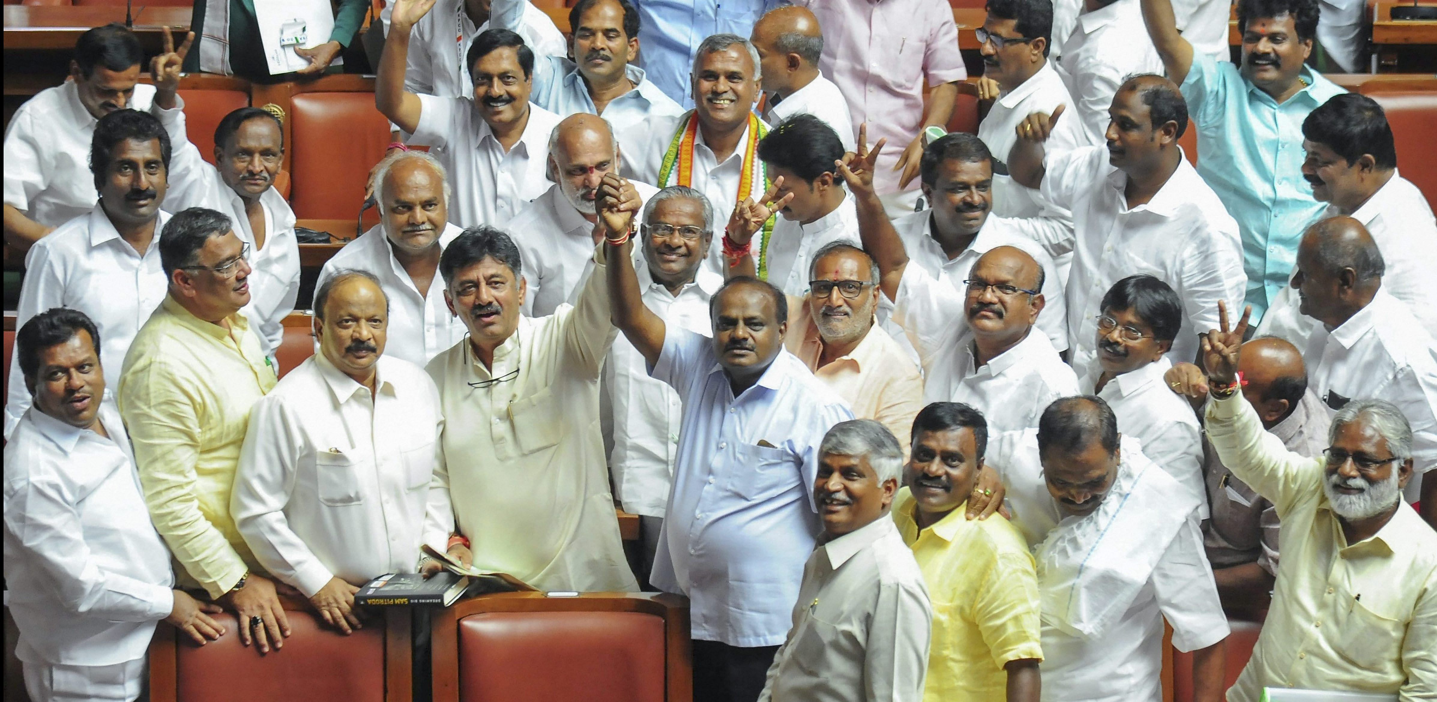 JD(S) leader H.D. Kumaraswamy and party MLAs show victory sign