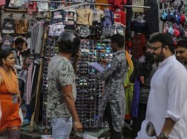 A shopper looks at sunglasses at a roadside stall in Mumbai, India.