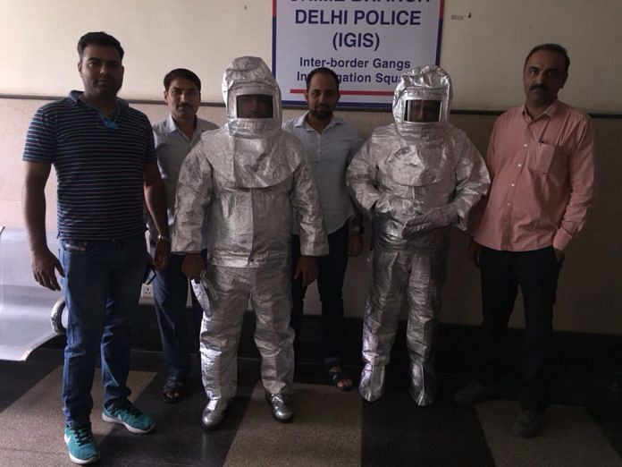 Delhi Police paraded two people in space suits which they used to scam a businessman | @DelhiPolice | Twitter