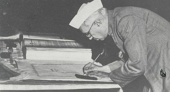 Jawaharlal Nehru signing the Constitution of India