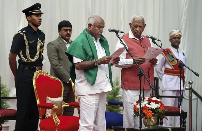 Karnataka Governor Vajubhai Vala administers oath to BJP leader B. S. Yeddyurappa as Chief Minister of the state at a ceremony in Bengaluru