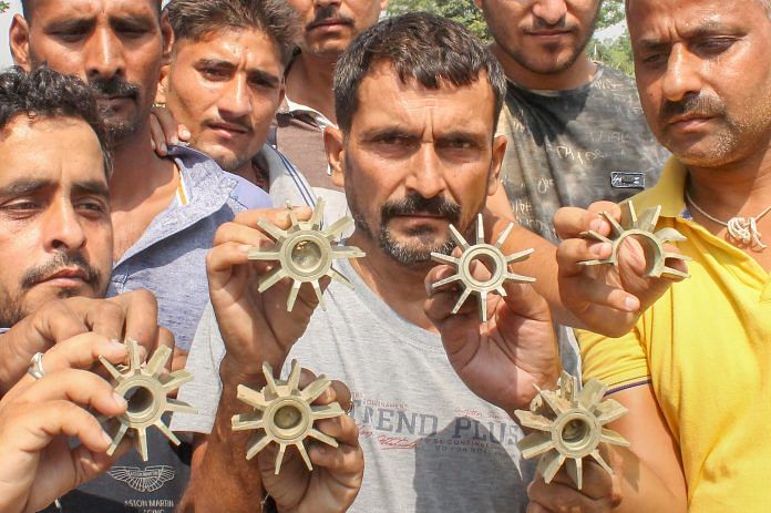 Villagers show mortar shells after firing by Pakistan, Jammu