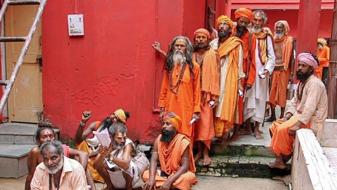 Sadhus wait in a queue for the registration for Amarnath Yatra | PTI