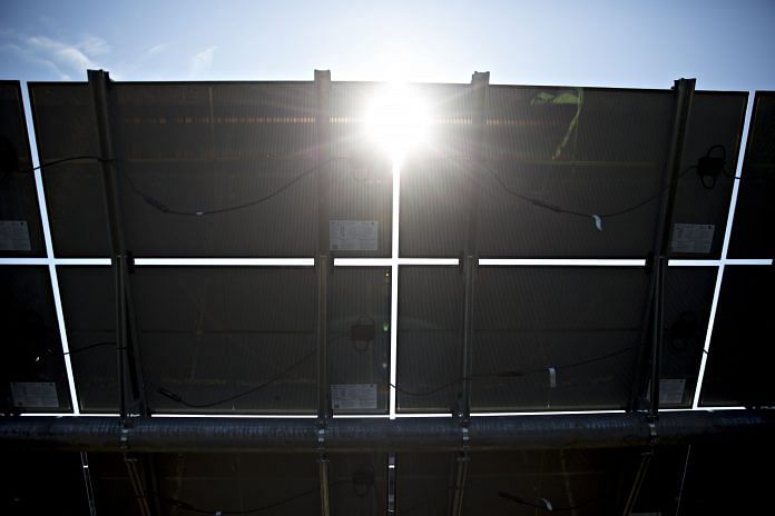 solar panels at a solar generating facility | Bloomberg