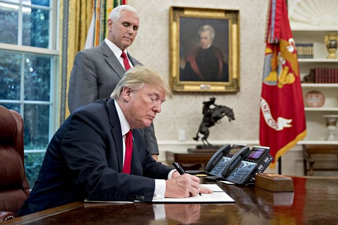 U.S. President Donald Trump signs an executive order to end family separations at the border