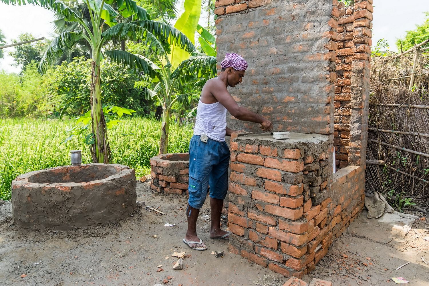 Man constructing toilet in a village in Muzaffarnagar, Bihar | Christopher Wilton-Steer/Aga Khan Development Network