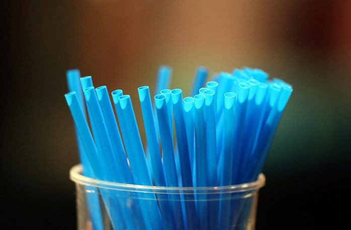 Blue straws in a glass | Godong/UIG via Getty Images