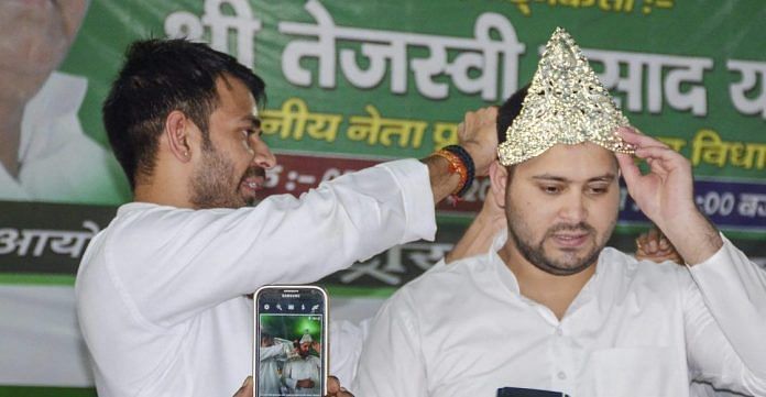 RJD leaders Tej Pratap crowns his brother Tejashwi Yadav during the 22nd Foundation Day of RJD in Patna | PTI