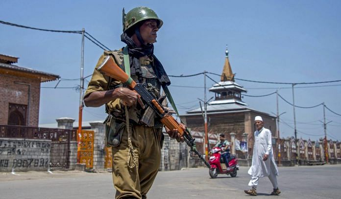 A security person stands guard during restrictions imposed by due to a strike called by the joint Hurriyat leadership against the arrest and shifting of Asiya Andrabi in Srinagar on Saturday | S. Irfan/PTI