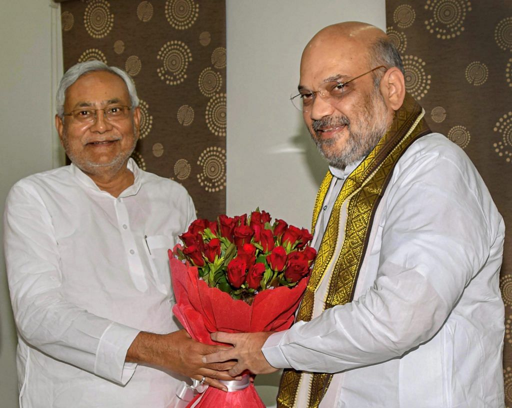 Nitish Kumar and Amit Shah exchange greetings at the state guest house in Patna / PTI