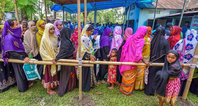 People wait to check their names on the final draft of the NRC in Nagaon | PTI