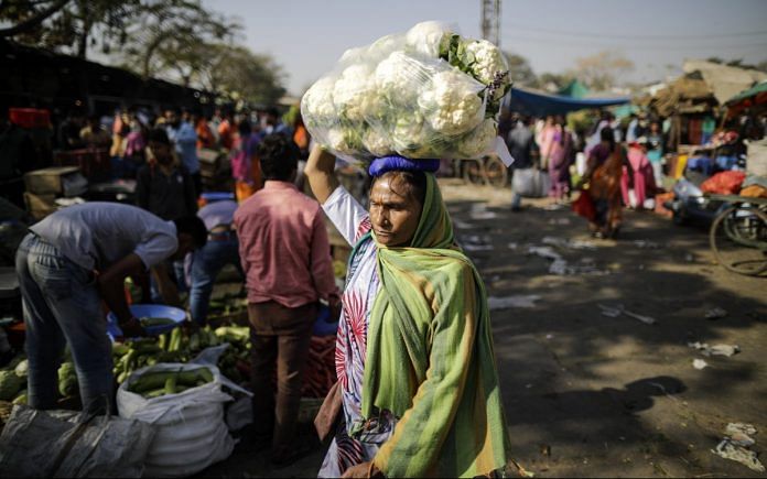 A woman at a vegetable market in Udaipur | Prashanth Vishwanathan/Bloomberg