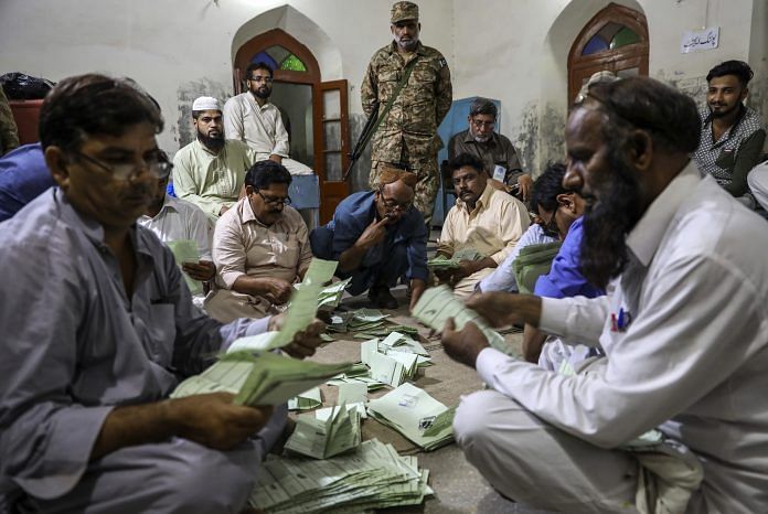 Polling agents count votes after polls close at a polling station in Lahore, Pakistan | Asad Zaidi/Bloomberg