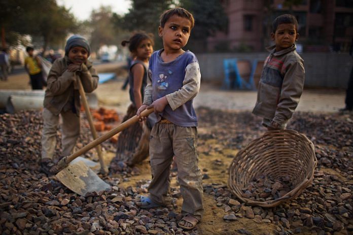 Indian children work at a construction project in New Delhi, India | Daniel Berehulak/Getty Images