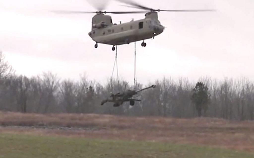 An M777 Ultra Light Howitzer underslung from a Chinook helicopter | YouTube