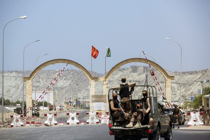 Members of the security forces stand guard at an entrance to Gwadar Port in Gwadar, Balochistan | Photographer: Asim Hafeez | Bloomberg