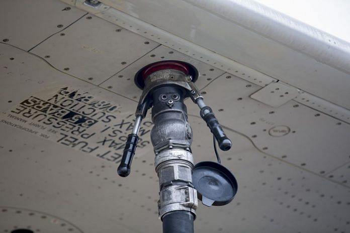 A fuel nozzle hangs attached to an Airbus SAS A319 aircraft | Lewin/Bloomberg