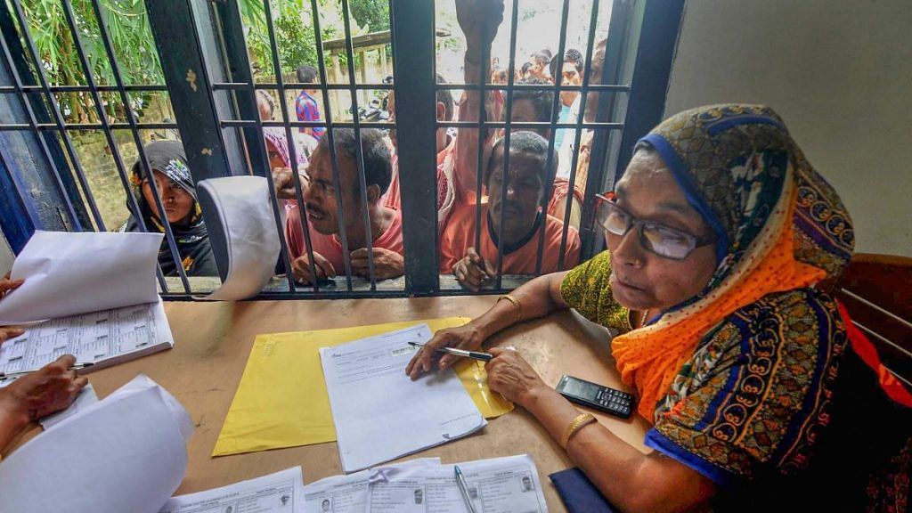 File photo | People queue to check their names on the final draft of the state's National Register of Citizens in Morigaon, July 2018 | PTI