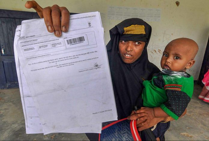 A woman shows an NRC acknowledgment receipt in Morigaon, Assam | PTI