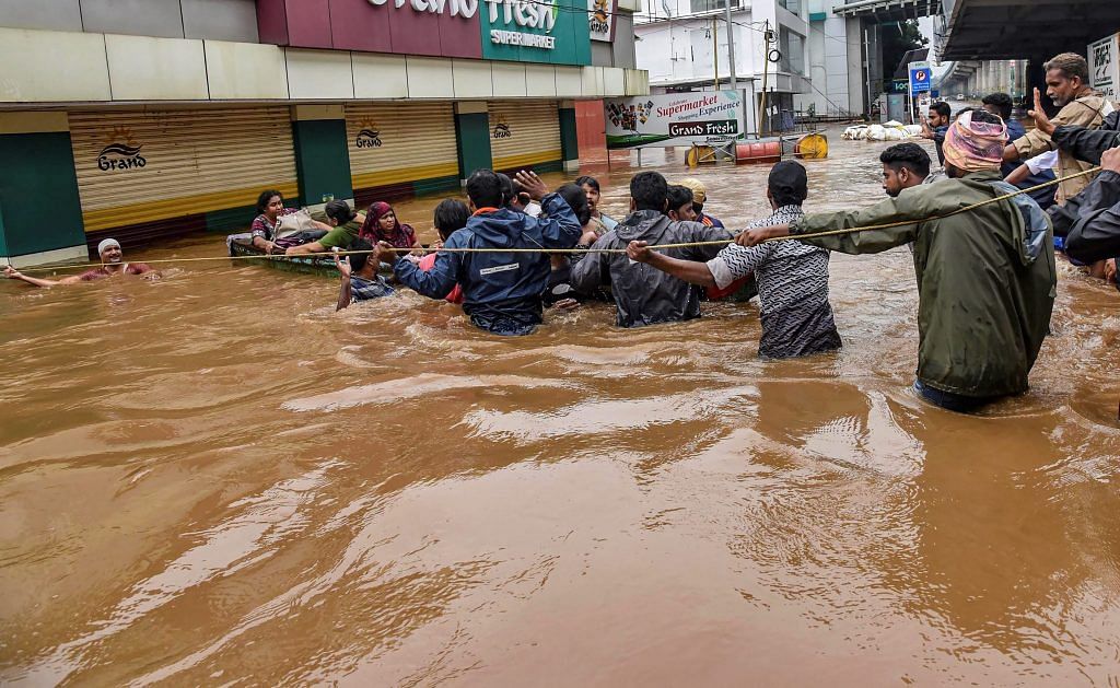 People being rescued from a flood-affected region following heavy monsoon rainfall, in Kochi | PTI