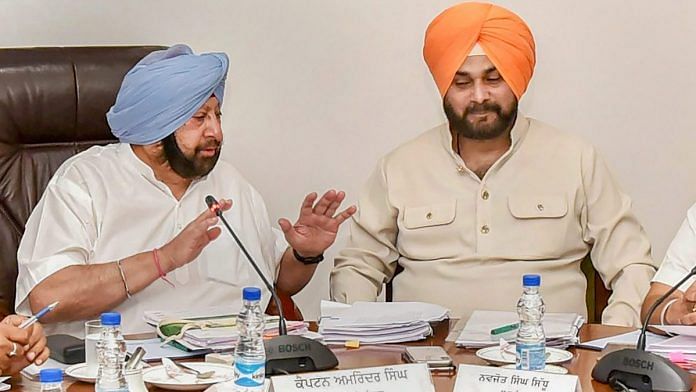 Punjab Chief Minister Captain Amarinder Singh with Navjot Singh Sidhu during a Cabinet meeting in Chandigarh