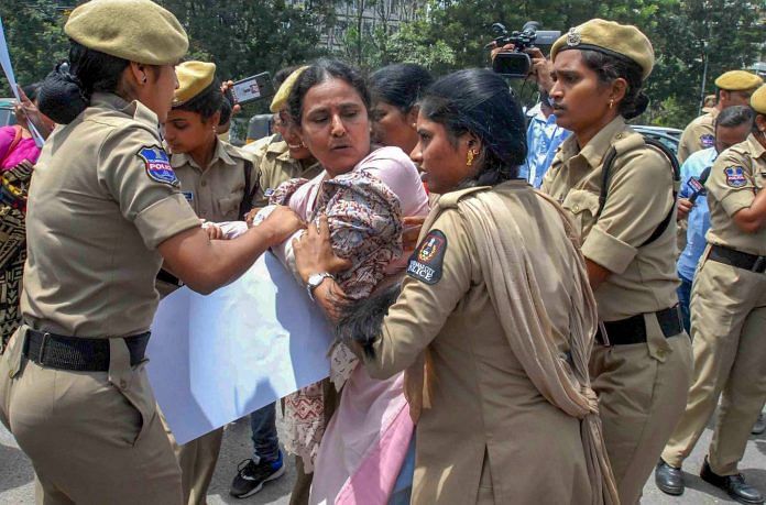 File image of police detaining a woman activist during a protest against the arrest of writer Varavara Rao and other activists in connection with Bhima-Koregaon violence, in Hyderabad. | PTI