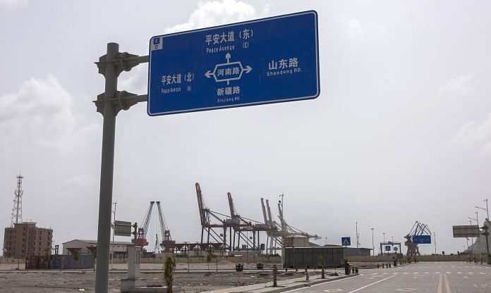 A Chinese road sign stands at the Gwadar Free Zone in Gwadar, Pakistan | Asim Hafeez/Bloomberg