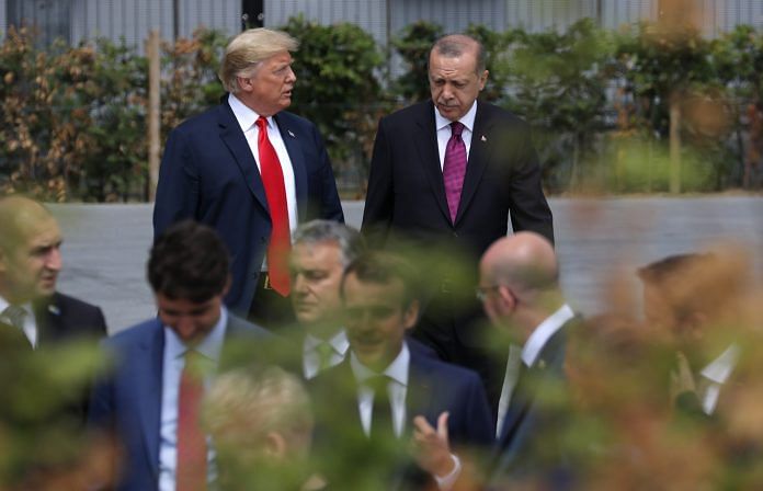 U.S. President Donald Trump walks with Recep Tayyip Erdogan at the (NATO) summit in Brussels, Belgium ~ Marlene Awaad/Bloomberg