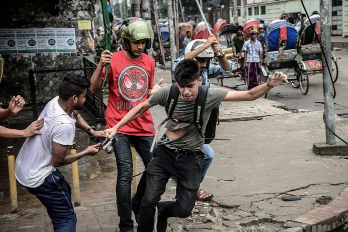A photographer is targetted during a student protest in Dhaka on August 5, 2018, following the deaths of two college students in a road accident. Mamunur Rashid/NurPhoto via Getty Images