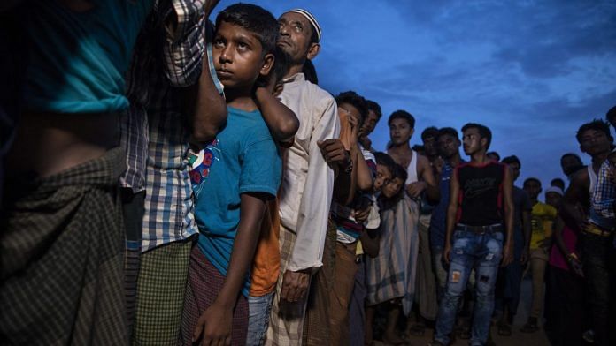 Rohingya refugees wait in line for humanitarian aid in Kutupalong camp | Paula Bronstein/Getty Images