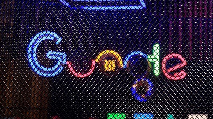 The Google Inc. logo hangs illuminated