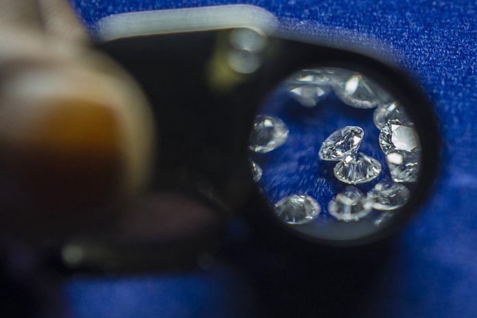 Cut and polished diamonds are seen through a loupe | Prashanth Vishwanathan/Bloomberg