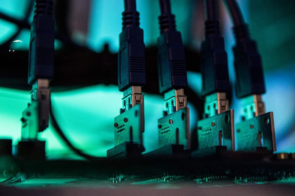 Lights illuminate USB cables inside a 'mining rig' computer | Akos Stiller / Bloomberg