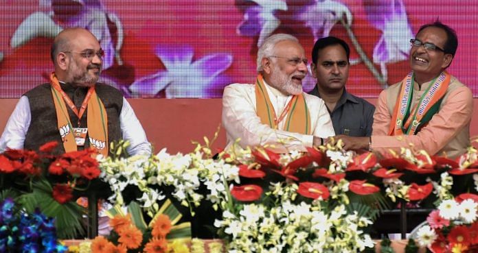 Narendra Modi flanked by BJP National President Amit Shah (L) and Madhya Pradesh Chief Minister Shivraj Singh Chouhan | PTI
