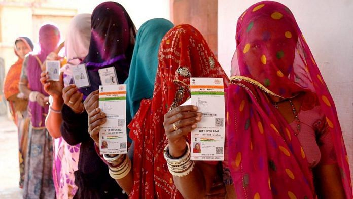 Rajasthani women show their Aadhaar cards while standing in a queue to vote | PTI