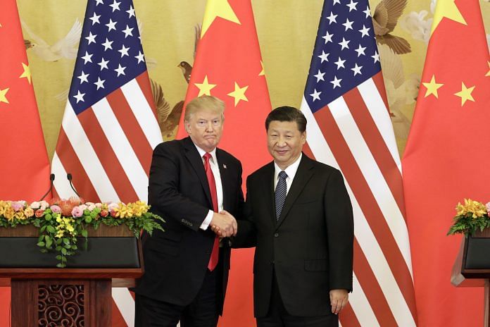U.S. President Donald Trump, left, and Xi Jinping, China's president in China in 2017 ~ Qilai Shen/Bloomberg