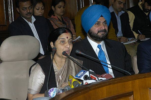 Navjot Singh Sidhu with Sushma Swaraj at Parliament House in New Delhi | Getty Images