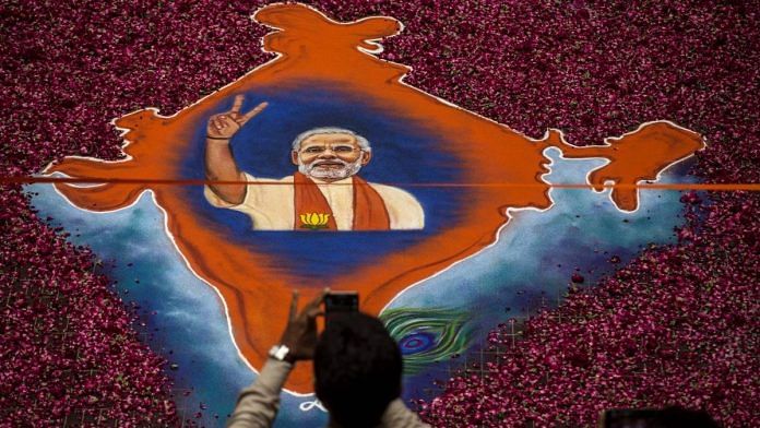 A map of India made with flowers and Narendra Modi's image, Ahmedabad | Kevin Frayer/Getty Images)