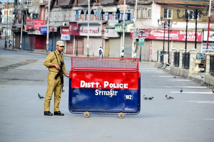 A policeman stands alert near a check point in Srinagar | Saqib Majeed/SOPA Images/LightRocket via Getty Images