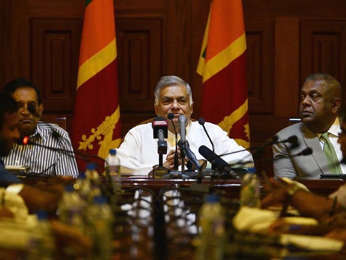 Sri Lanka's ousted prime minister Ranil Wickremesinghe (C) takes part in a press conference in Colombo | LAKRUWAN WANNIARACHCHI/AFP/Getty Images