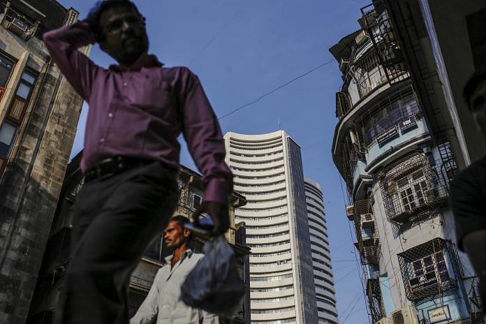 Pedestrians walk past the Bombay Stock Exchange building in Mumbai | Dhiraj Singh/Bloomberg