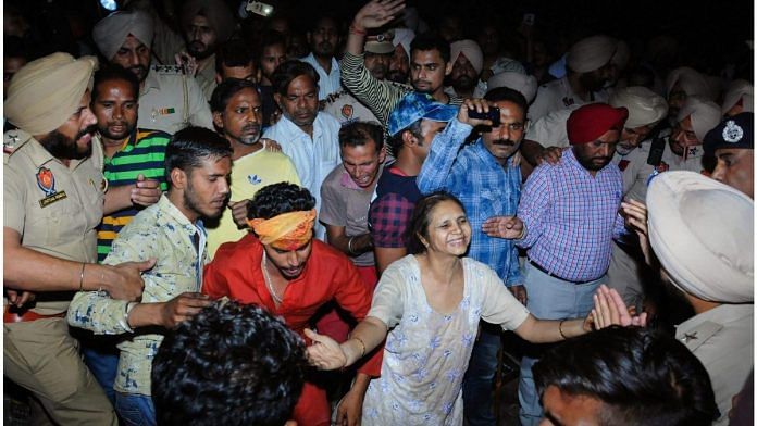 Relatives mourn at the site of a train accident at Joda Phatak in Amritsar, Friday