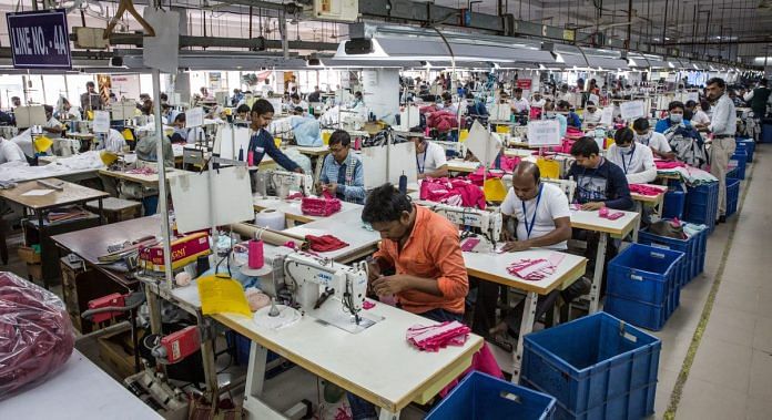 Employees operate sewing machines at a garment factory in Kolkata | Taylor Weidman/Bloomberg