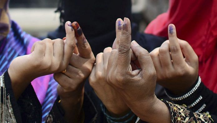 Muslim women show their ink stained finger after casting their vote | Sheeraz Rizvi/Hindustan Times via Getty Images
